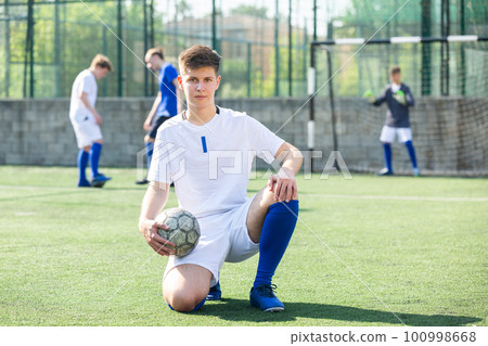 Portrait of football player holding football Portrait of football player holding football 100998668