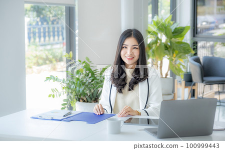 Business woman bookkeeper's use laptops doing account for paying taxes in the working office Business woman bookkeeper's use laptops doing account for paying taxes in the working office 100999443