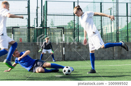 Young football players fighting for ball 100999502