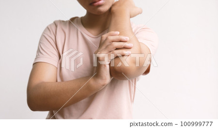 Woman hand massage physiotherapy elbow is sore and numb, exhausted, tingling. Guillain-Barre Syndrome, a side effect of the Covid-19 vaccination 100999777