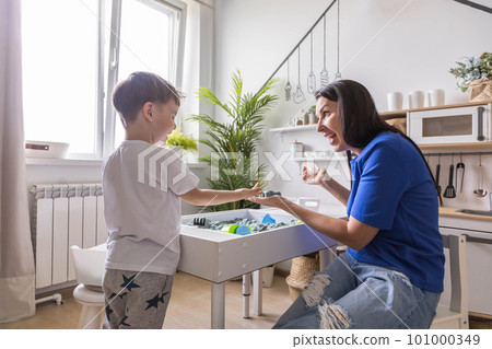 Happy mother and son playing with kinetic sand development of fine motor skills at home Happy mother and son playing with kinetic sand development of fine motor skills at home 101000349