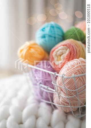 Cozy homely atmosphere. Female hobby knitting. Yarn pastel multicolor in a basket. Skeins, balls, knitting needles, hooks and scissors. Cozy homely atmosphere. Female hobby knitting. Yarn pastel multicolor in a basket. Skeins, balls, knitting needles, hooks and scissors. 101000518