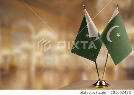 Small flags of the Pakistan on an abstract blurry background 101002458