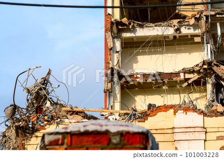 dismantled old building. Half demolished house, dismantling of the old one for the construction of a new building dismantled old building. Half demolished house, dismantling of the old one for the construction of a new building 101003228