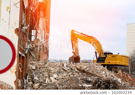 dismantling of the building, an excavator destroys an old building 101003234