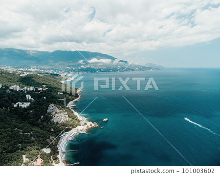 Christian church in the mountains above the sea. Temple of the Holy Archangel Michael in Oreanda. The southern coast of Crimea. Aerial view Christian church in the mountains above the sea. Temple of the Holy Archangel Michael in Oreanda. The southern coast of Crimea. Aerial view 101003602