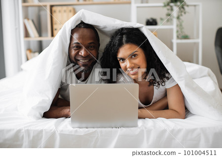 Happy family of two having fun with laptop at home Happy family of two having fun with laptop at home 101004511