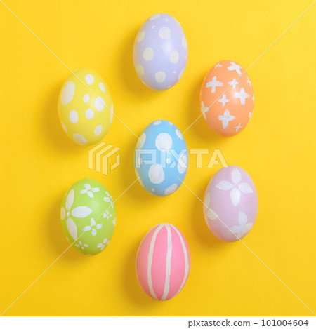 Happy easter holiday celebration concept. Group of painted colourful eggs decoration on a yellow background. Seasonal religion tradition design. Top view, flat lay, copy space. 101004604