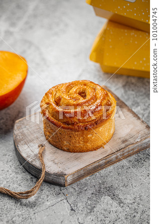Fresh baked sweet swirl bun roll on serving board 101004745
