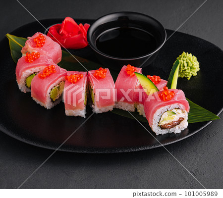 rolls with tuna and red caviar on a black plate rolls with tuna and red caviar on a black plate 101005989
