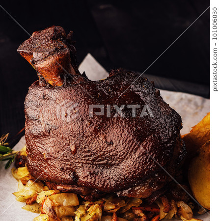 Roasted pork knuckle eisbein with on wooden cutting board Roasted pork knuckle eisbein with on wooden cutting board 101006030