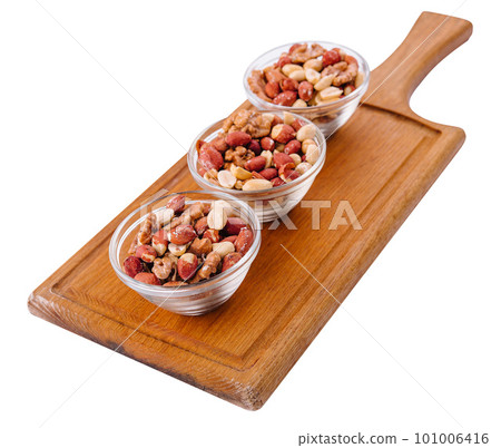 Assorted nuts in a glass bowls on wooden Assorted nuts in a glass bowls on wooden 101006416