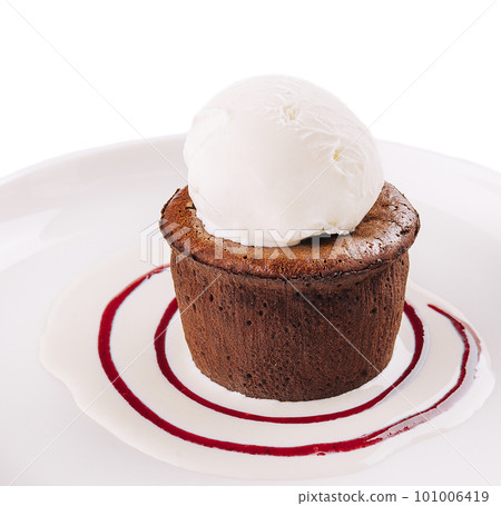 Chocolate fondant and a scoop of ice cream in a white plate Chocolate fondant and a scoop of ice cream in a white plate 101006419