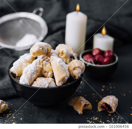 Homemade fresh cookies dusted powdered sugar in black plate 101006456