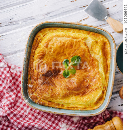 Delicious pie with meat and basil on wooden table 101006461