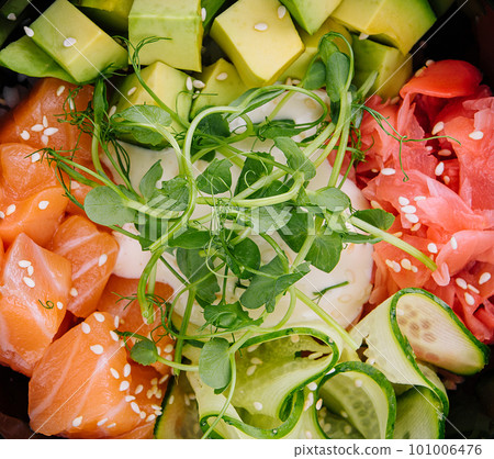 A bowl of salmon poke with avocado 101006476
