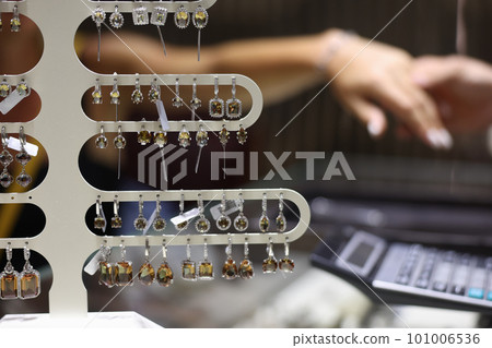 Lot of precious earrings with stones sold in jewelry store closeup 101006536