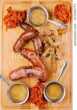 Delicious fresh grilled sausages on wooden table Delicious fresh grilled sausages on wooden table 101006751