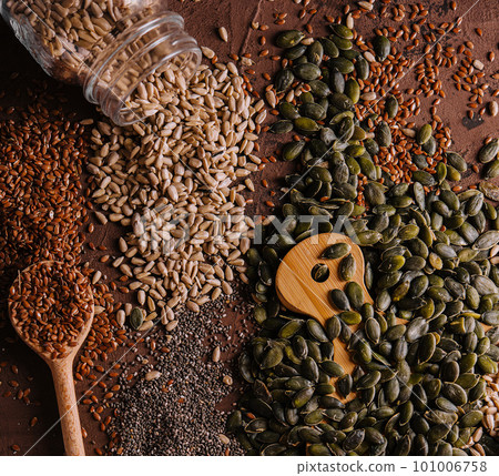 Different types of grains and seeds on shabby wooden Different types of grains and seeds on shabby wooden 101006758