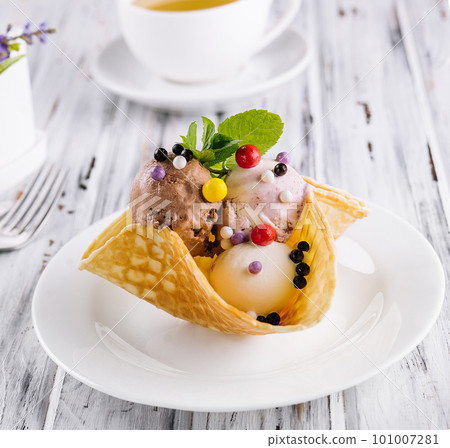Three scoops of natural organic fruit ice cream in a wafer cup 101007281