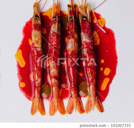 Grilled tiger prawns on a ceramic plate, top view Grilled tiger prawns on a ceramic plate, top view 101007335
