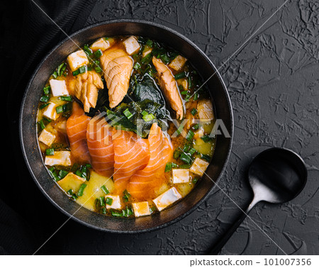 Appetizing ishikari miso soup with salmon in a black bowl 101007356