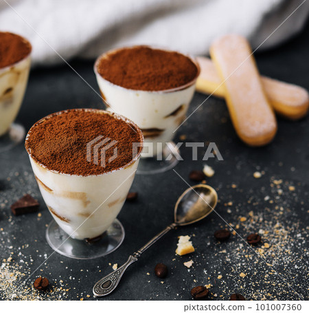 Italian dessert tiramisu in glass and eclairs with chocolate slices Italian dessert tiramisu in glass and eclairs with chocolate slices 101007360