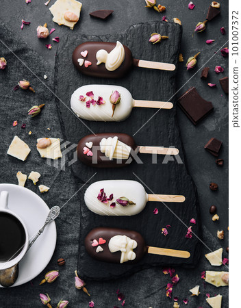 Top view of decorated cake pops ice creams on black background Top view of decorated cake pops ice creams on black background 101007372