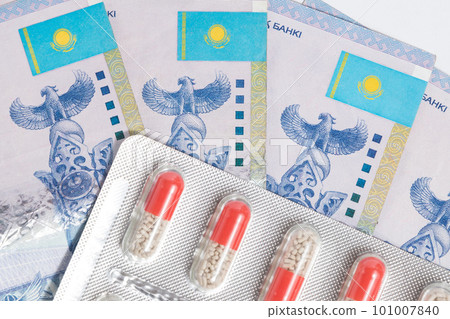Top view on blister with medical pills drug with Tenge Kazakhstan money 101007840
