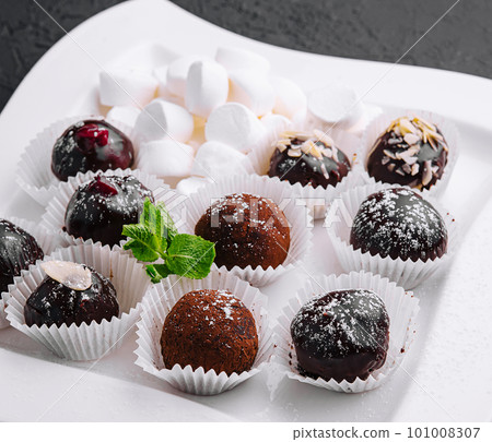 Boxes with tasty chocolate candies with marshmallow Boxes with tasty chocolate candies with marshmallow 101008307
