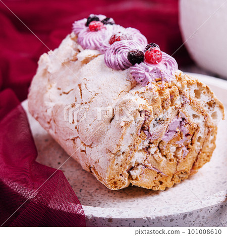 Meringue roll pavlova cake with cream and berries 101008610