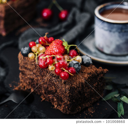 Delicious chocolate cake decorated with fresh berries Delicious chocolate cake decorated with fresh berries 101008668
