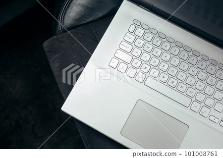Opened silver laptop on a leather car seat. Work in trip 101008761