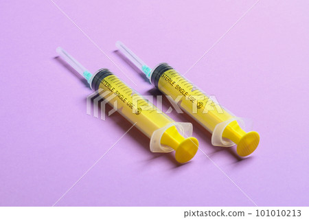Top view of syringes in a row for medical injection on colorful background with copy space. Health and vaccination concept 101010213