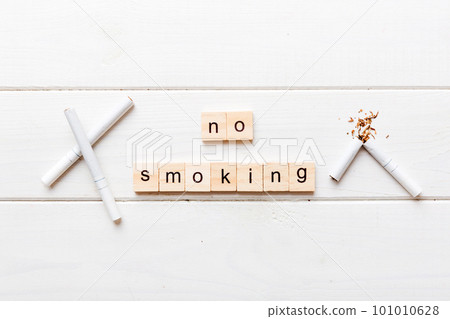 Cigarette And Wooden Blocks, Broken cigarette on table background, No Tobacco Day with hourglass, clock health concept. time to quit smoking 101010628