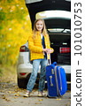 Adorable girl with a suitcase ready to go on vacations with her parents. Child looking forward for a road trip or travel. Autumn break at school. 101010753