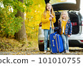 Two adorable girls with a suitcase going on vacations with their parents. Two kids looking forward for a road trip or travel. Autumn break at school. 101010755