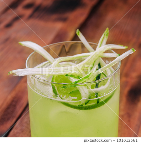 Glass of fresh mojito on wooden table 101012561