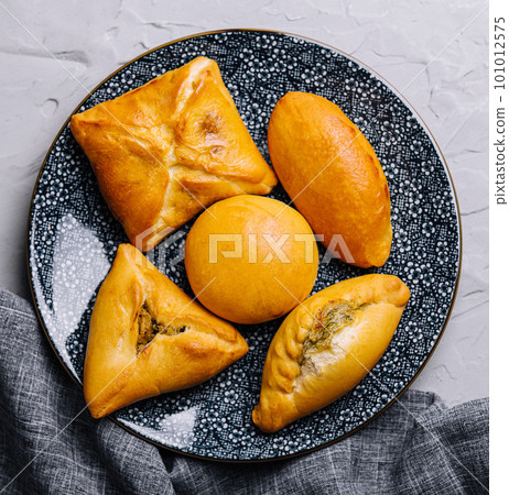 Heap of fresh tasty puff pastries 101012575