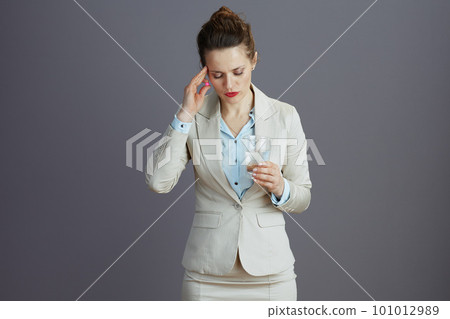 stressed 40 years old woman worker in light business suit 101012989