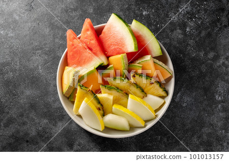 Fruits assortment platter antipasti, watermelon, pineapple, melon and strawberries. Dark background Fruits assortment platter antipasti, watermelon, pineapple, melon and strawberries. Dark background 101013157