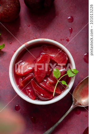 Red plums confiture, jam or fruit sauce in a bowl, top voiew 101013226