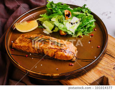 Grilled salmon and vegetables on plate Grilled salmon and vegetables on plate 101014377