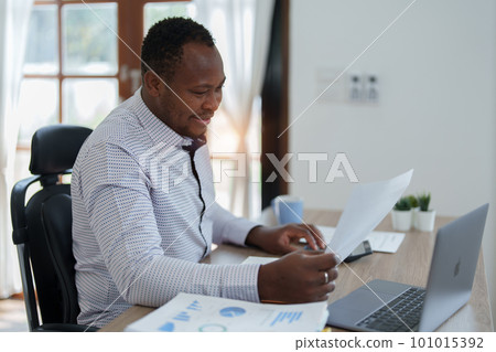 middle aged man American African using computer laptop with planning working on financial document, tax, exchange, accounting and Financial advisor. middle aged man American African using computer laptop with planning working on financial document, tax, exchange, accounting and Financial advisor. 101015392