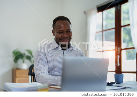 middle aged man American African using computer laptop with planning working on financial document, tax, exchange, accounting and Financial advisor. middle aged man American African using computer laptop with planning working on financial document, tax, exchange, accounting and Financial advisor. 101015396