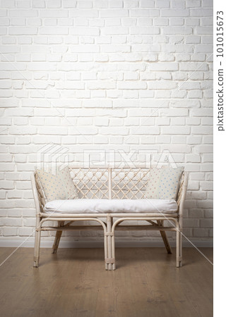 Rattan Living Room Loveseat on white brick wall background 101015673