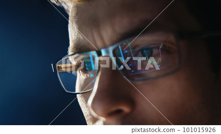 Close up view of focused trader wears eyeglasses looking at pc screen with stock market charts 101015926