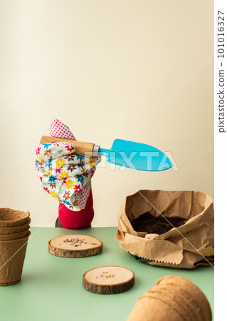 Hand in a glove planting tomato seeds Hand in a glove planting tomato seeds 101016327