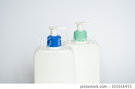 Two white plastic bottles with black dispenser, isolated on white background 101016455