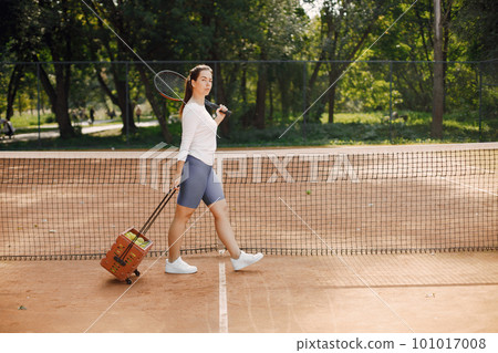 Tennis player going through tennis curt. Model posing. Hobbies, sports, equipment. Tennis player going through tennis curt. Model posing. Hobbies, sports, equipment. 101017008